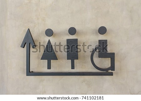 modern public toilet sign on the cement wall