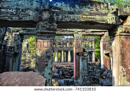 Preah Khan meaning "The Sacred Sword" Angkor, Cambodia. Ruins & crumbling outer walls, columns and pillars - remnants of a bygone era