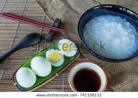 Porridge is a breakfast that comes with boiled eggs on the table. For Thai or Chinese style on wooden floor.