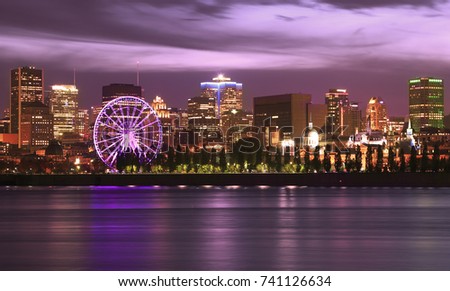 Montreal skyline and St Lawrence River illuminated at night, Quebec, Canada