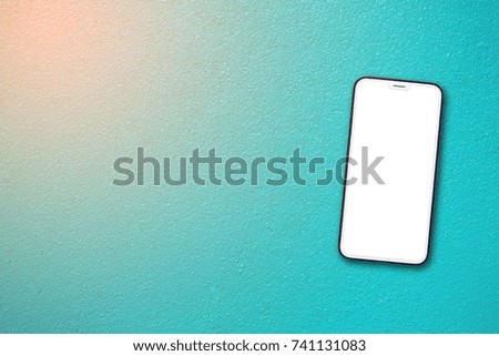 Mock up image of  White Mobile cell phone with blank screen on concrete wall color is blue