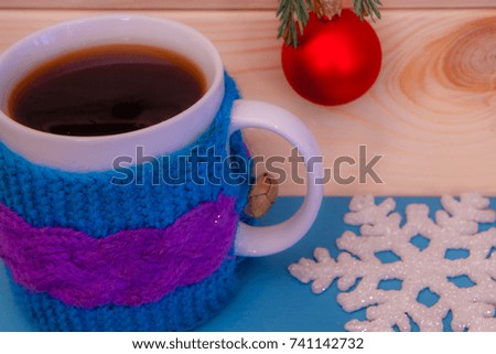 Winter drink with wooden snowflake  and red toy ball decoration