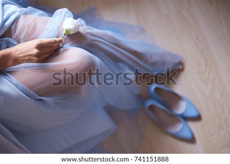 Young bride sitting on the bed at home