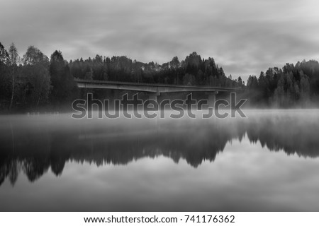Beautiful foggy morning on a bridge at Jevnaker Lake Oslo Norway Royalty-Free Stock Photo #741176362