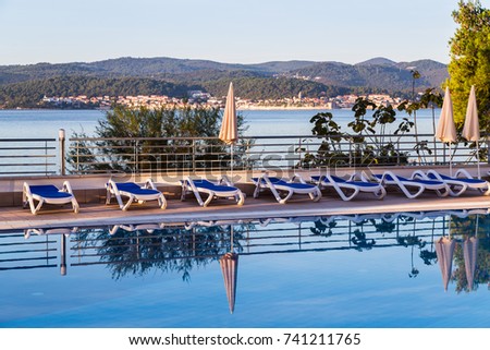 The still water on a hotel swimming pool pictured in front of Korcula old town which shuts out into the Peljesac Channel on its own peninsula.