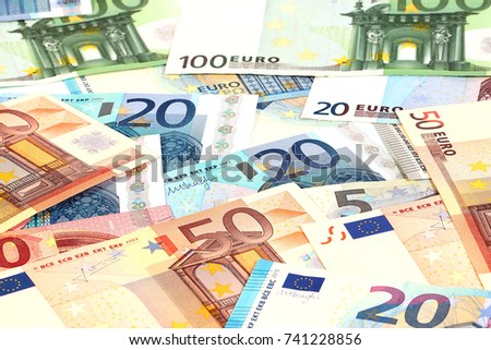 a small pile of paper euro bills as part of the trading system