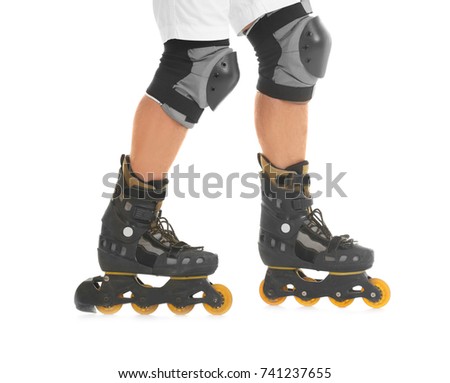 Legs of young man on roller skates against white background