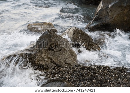 Stones with water and spray, splash. Sea coast