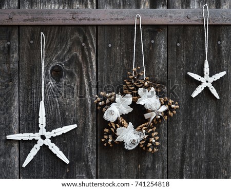Handmade Christmas ornaments hanging on the rope on the rustic wooden background. Selective focus. 