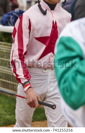 Jockeys after the race. Hippodrome background. Racehorse. Competition