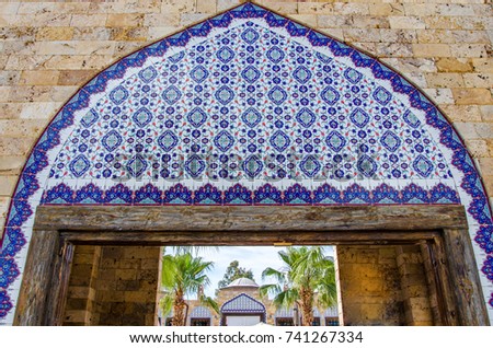Turkish ceramic decor. Ceramic tile. Traditional Turkish motif of wall decoration. The gate is decorated with a Turkish tile of blue.