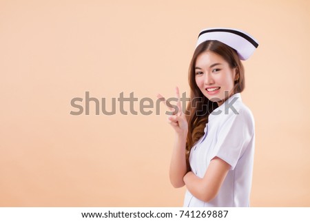 asian nurse pointing two fingers up, v victory hand sign