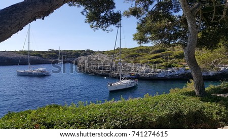 Anchored sailing yachts at Morro de Cala Mitjana, Mallorca, south of Portocolom Royalty-Free Stock Photo #741274615