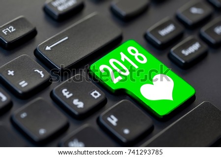 2018 written on a computer keyboard and a heart