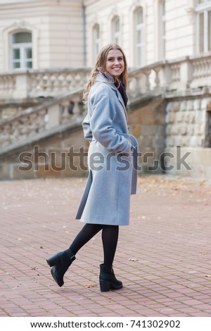 Beautiful young woman wearing grey coat 