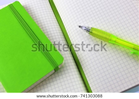 An image of a white paper block with a pen and copy space