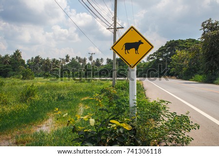 Warning sign alert the cow and buffalo while driving with yellow sign reflecting light to be visible at night in the countryside of Thailand