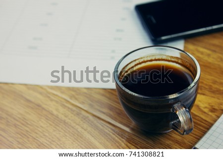 black coffee with business objects on  table