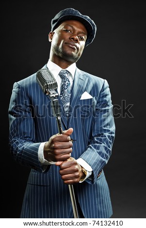 Black man with blue striped suit and cap singing. Jazz musician. Night club. Cotton club. New Orleans.