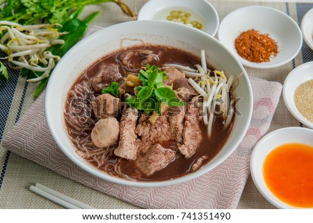 Noodles with pork and pork balls with soup Thai style. Thai peoples call Boat Noodles. Close up or selective focus Royalty-Free Stock Photo #741351490