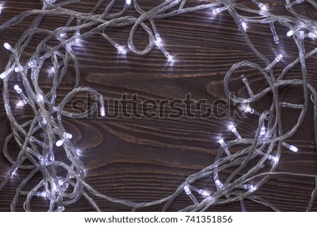 Christmas background with wooden table and LED lamps 