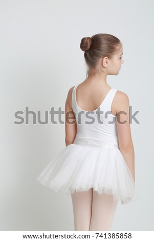 Beautiful little ballerina in studio posing as a model