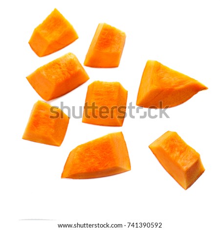 Pumpkin pieces cut in a  cube slice isolated on white background. Diced Pumpkin, close up.