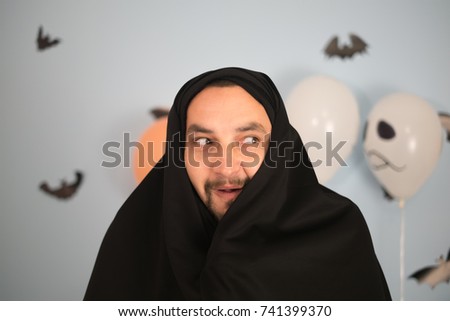 halloween man in a black raincoat
