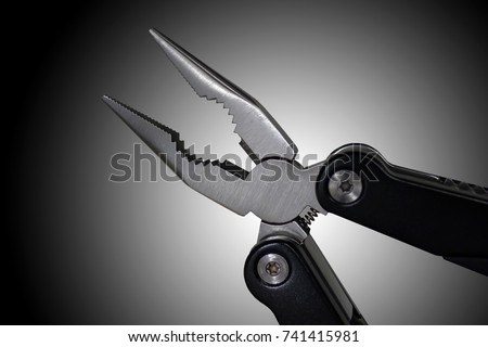 Long nose pliers with gradient black and white background.