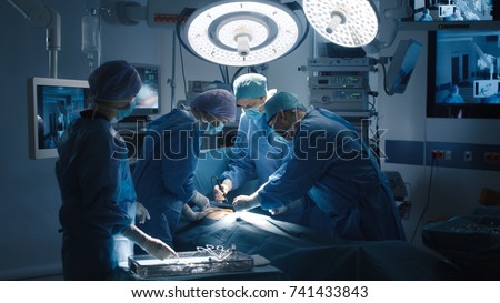Medical Team Performing Surgical Operation in Modern Operating Room Royalty-Free Stock Photo #741433843