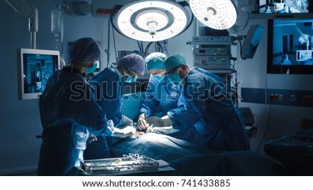 Medical Team Performing Surgical Operation in Modern Operating Room Royalty-Free Stock Photo #741433885