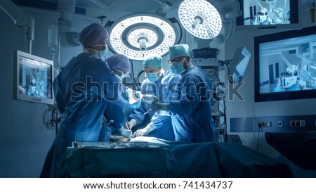 Medical Team Performing Surgical Operation in Modern Operating Room Royalty-Free Stock Photo #741434737