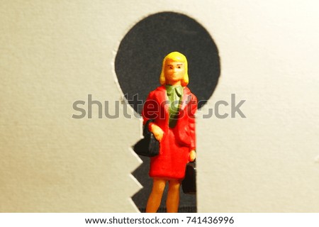 Paper cut into the keyhole shape in the scene appear businesswoman miniature figure model also .