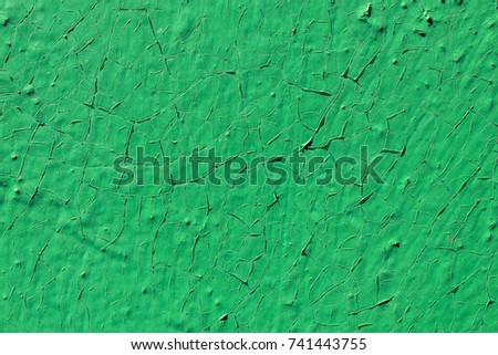 Cracks on green background surface. Peeling of verdant cracked paint. Effect of rubbing, craquelure, exfoliation, fissure, wrinkling, grunge texture, scratches, flaw roughness for Photoshop, picture