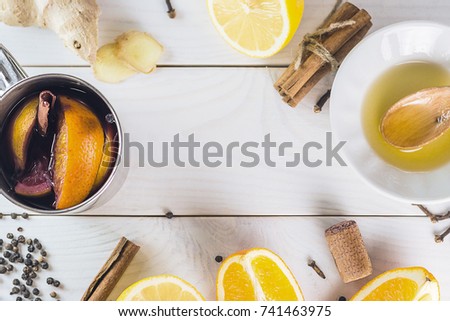 Spices, citrus, honey - ingredients for mulled wine on a white wooden background.