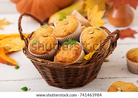 Appetizing and ruddy muffins with pumpkin and walnut.