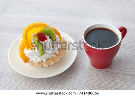 dessert with fruits, cream and cup of coffee. on wooden background.