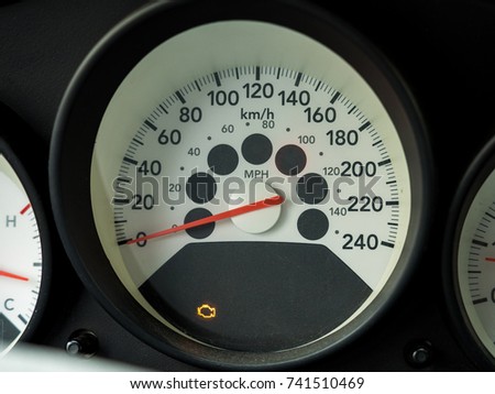 Check engine light. Car dashboard in closeup. White Car speedometer.