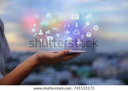 Mobile application concept.Man using touch screen smart phone on blurred urban city background Royalty-Free Stock Photo #741533173