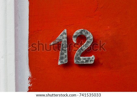 number 12 House number on the wall twelve (12)