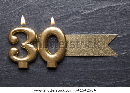 Gold number 30 celebration candle with glitter label