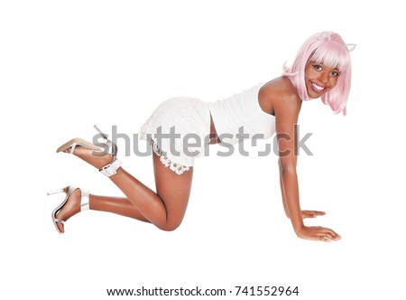 A gorgeous African woman in white shorts and t-shirt with a pink wig
on her knees on the floor, isolated for white background
