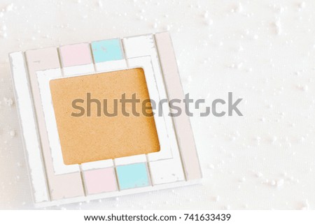 Photo frame of pastel color and copy space on snow flake background.