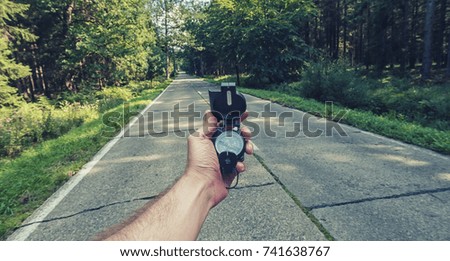 Travel Concept man hand hold Compass on the road in the outback. Point of view shot  Royalty-Free Stock Photo #741638767