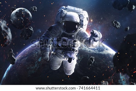 Picture of astronaut spacewalking with glowing stars and asteroids. Deep space image, science fiction fantasy in high resolution ideal for wallpaper and print. Elements of this image furnished by NASA