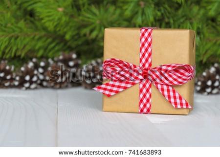 Christmas gift box. Christmas present in gift box at white wooden table. 