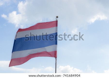 picture of waving Thai flag of thailand with blue sky background., king bhumipol