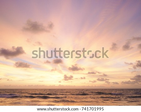 Colorful sunset on the tropical beach with beautiful sky, clouds,  soft waves.