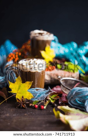 Autumnal concept with bright yellow leaves and cup of coffee  in rustic style with copyspace