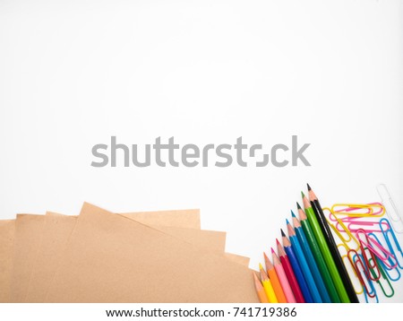  Stationery included brown papers,color pencils and colorful paper clips on white background and  copy space
